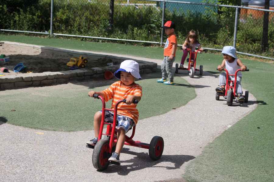 children riding tricycles